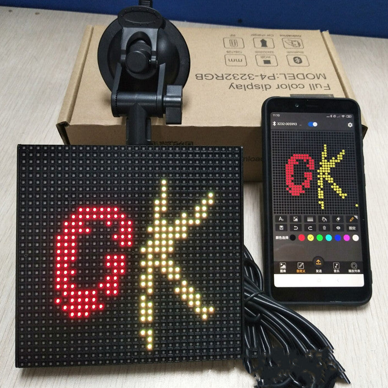 A vibrant square LED car display showcasing colorful emoticons and text, controlled via Bluetooth app.